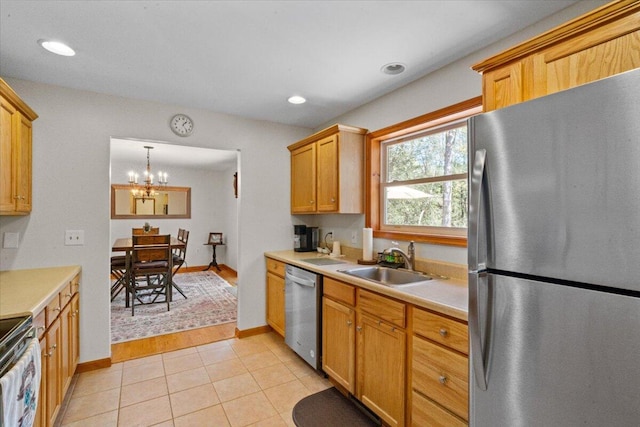 250 Grouse Run, Cresco, PA 18326 - kitchen featuring appliances with stainless steel finishes, a sink, light countertops, a chandelier, and baseboards