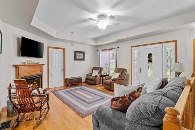 250 Grouse Run, Cresco, PA 18326 - living room with light wood-style flooring, ceiling fan, a raised ceiling, and a fireplace