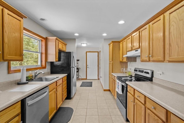 250 Grouse Run, Cresco, PA 18326 - kitchen featuring appliances with stainless steel finishes, under cabinet range hood, a sink, light tile patterned flooring, and light countertops