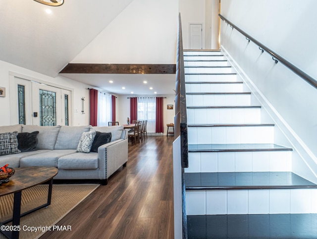 stairs with recessed lighting, lofted ceiling, and wood finished floors