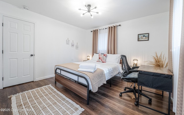 bedroom featuring baseboards and wood finished floors