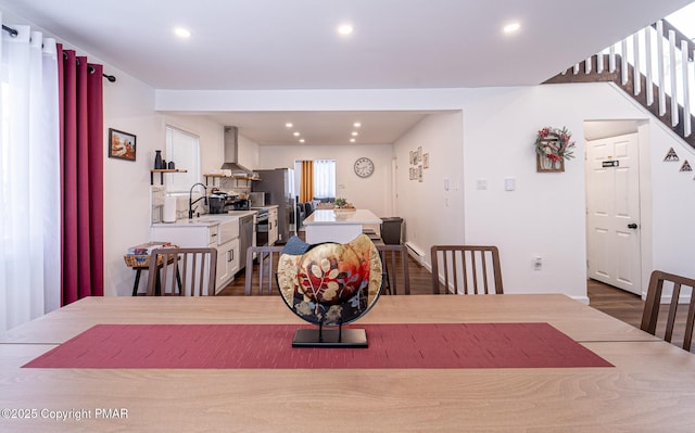 dining space with dark wood finished floors and recessed lighting