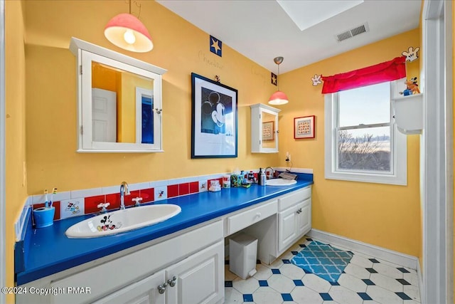 bathroom with tile patterned floors, visible vents, a sink, and double vanity