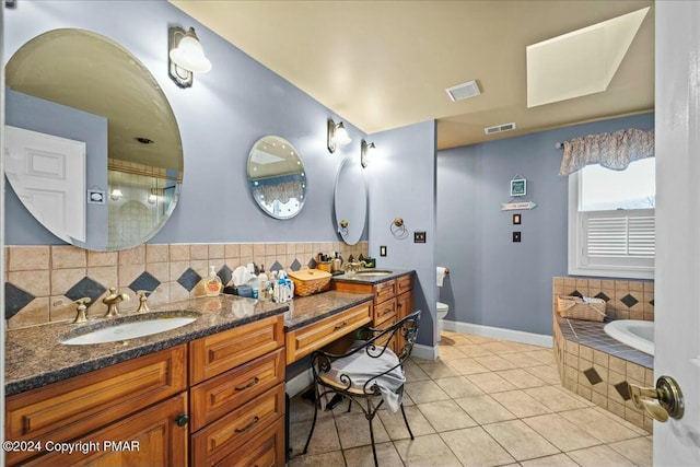 bathroom featuring visible vents, a sink, backsplash, and toilet