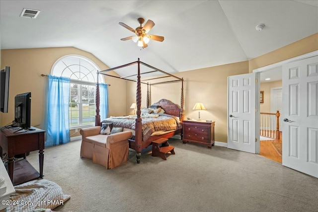 bedroom featuring carpet floors, visible vents, vaulted ceiling, and a ceiling fan