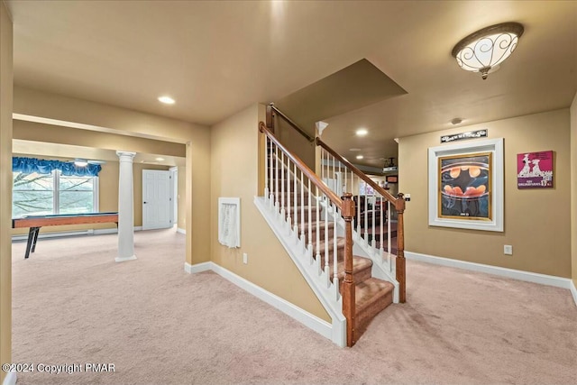 stairway with carpet floors, decorative columns, and baseboards