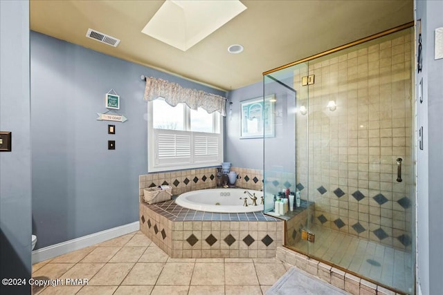 bathroom featuring a skylight, visible vents, tile patterned floors, a shower stall, and a bath