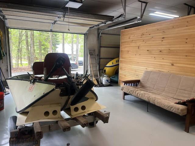 223 Outer Dr, Pocono Lake, PA 18347 - garage featuring wood walls and a garage door opener