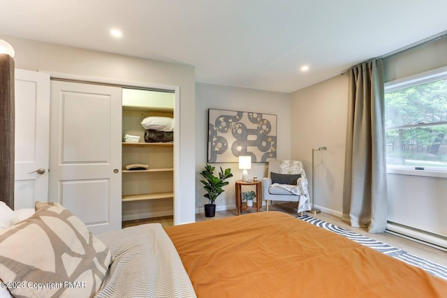 bedroom featuring baseboards, a closet, a walk in closet, and recessed lighting