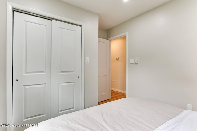 bedroom with a closet and wood finished floors