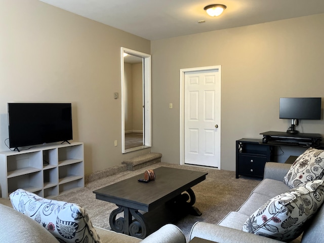 carpeted living area with stairway