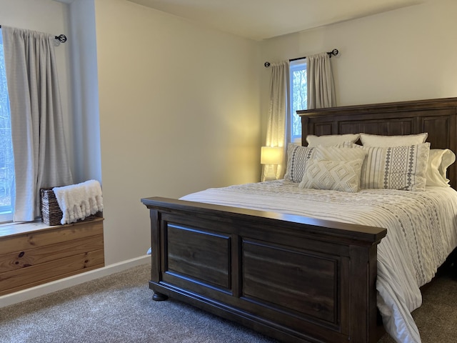 carpeted bedroom featuring baseboards