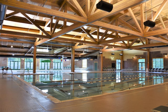 interior space with high vaulted ceiling and beam ceiling