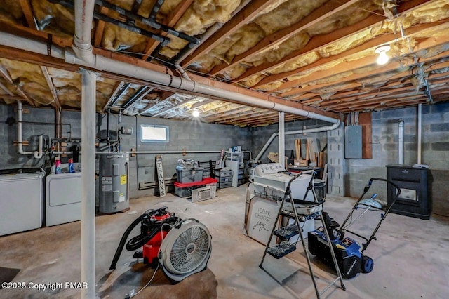 basement featuring water heater, washing machine and clothes dryer, and electric panel