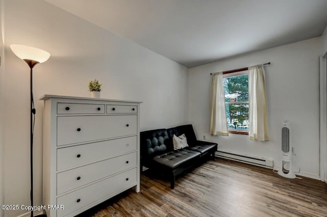 sitting room featuring hardwood / wood-style floors and baseboard heating