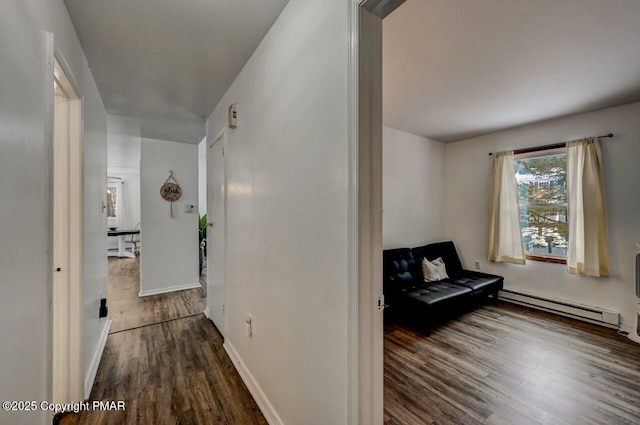 hall with baseboard heating and dark hardwood / wood-style flooring