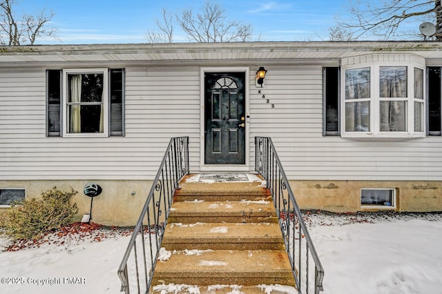 view of snow covered property entrance