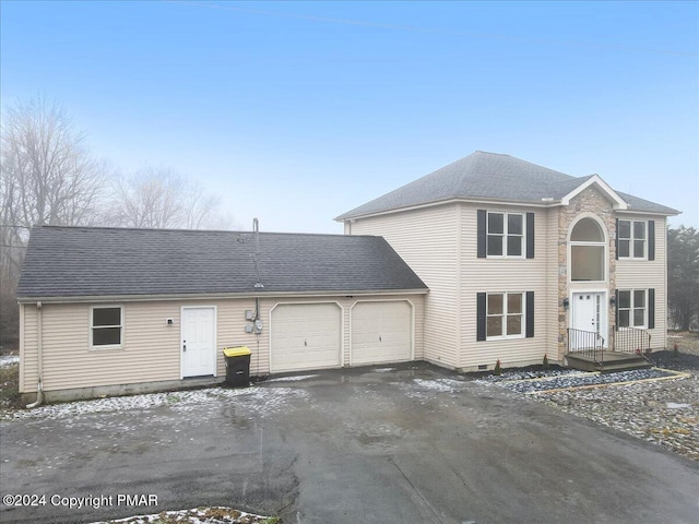 view of front of house with a garage, a shingled roof, and aphalt driveway