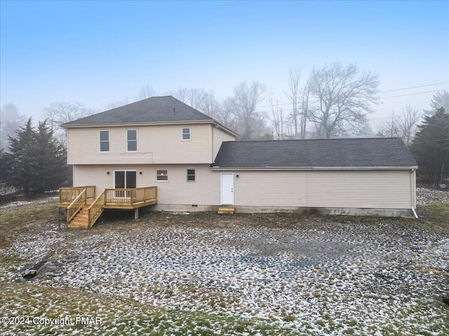 back of house featuring crawl space, roof with shingles, and a wooden deck