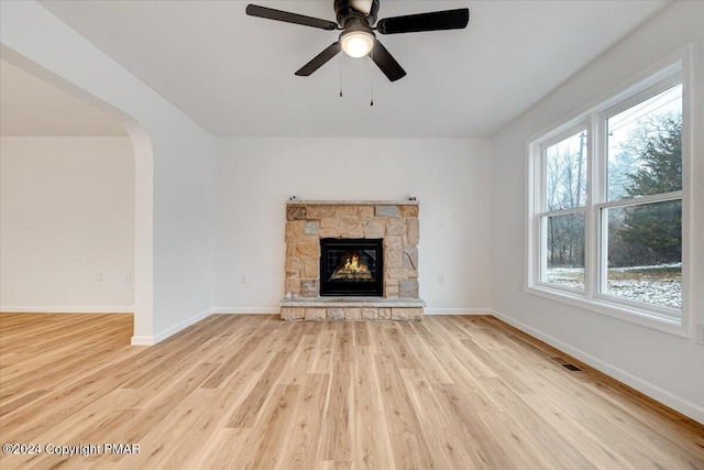 unfurnished living room featuring a wealth of natural light, baseboards, visible vents, and light wood finished floors