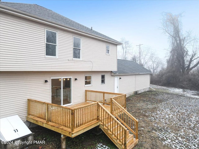 back of property featuring roof with shingles and a wooden deck