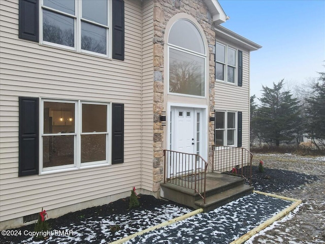 view of front of home featuring crawl space and stone siding