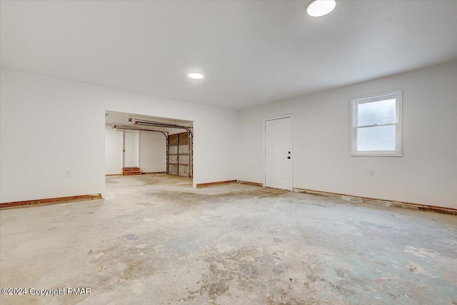 spare room with concrete flooring and baseboards