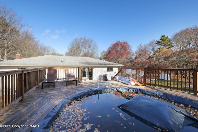 back of house with a pool side deck