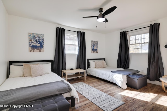 bedroom featuring hardwood / wood-style flooring and ceiling fan