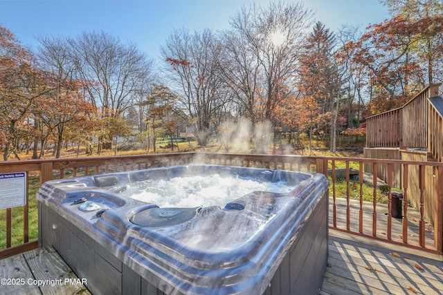 wooden deck featuring a hot tub