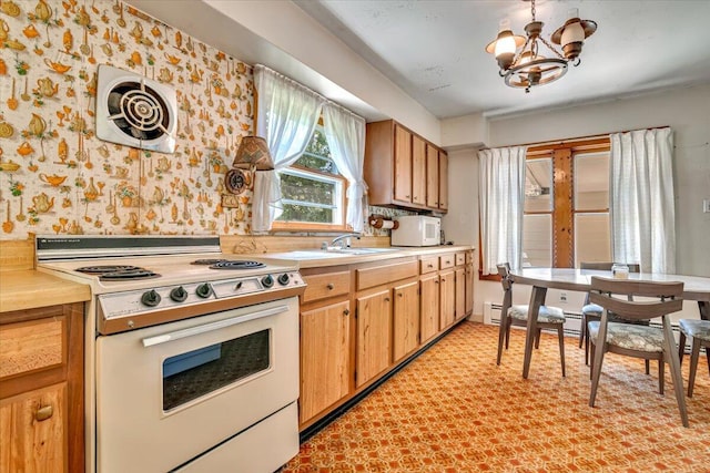 207 Scenic Dr, Kunkletown, PA 18058 - kitchen with white electric stove, a chandelier, light countertops, a baseboard heating unit, and wallpapered walls