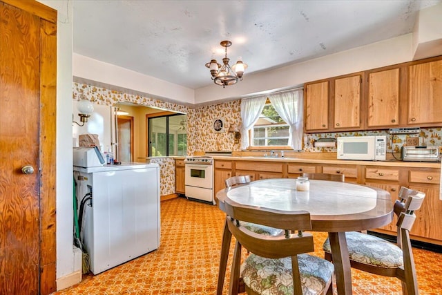 207 Scenic Dr, Kunkletown, PA 18058 - kitchen featuring white appliances, a chandelier, light countertops, brown cabinetry, and light floors