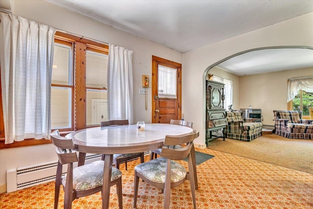 207 Scenic Dr, Kunkletown, PA 18058 - dining space with arched walkways, a baseboard heating unit, and carpet flooring