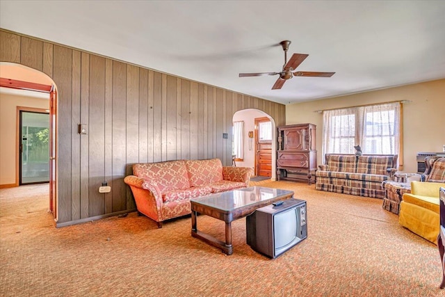 207 Scenic Dr, Kunkletown, PA 18058 - living room featuring arched walkways, carpet floors, ceiling fan, and wood walls