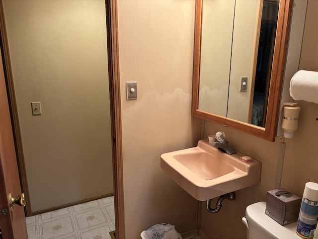 200 Onocop Dr, Pocono Lake, PA 18347 - bathroom featuring toilet, a sink, and tile patterned floors