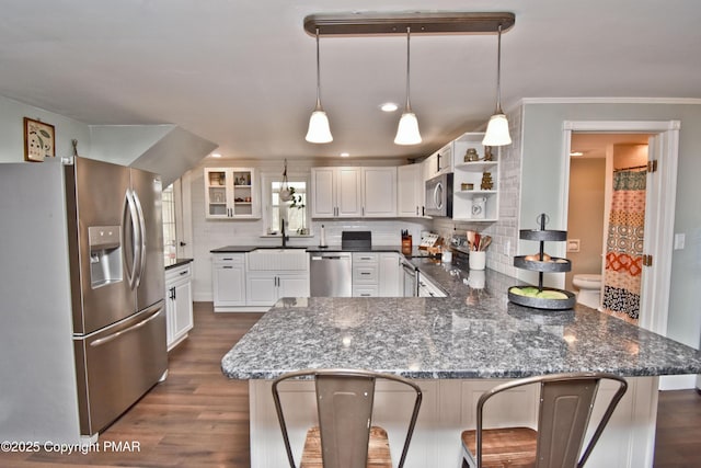 kitchen featuring dark wood-style flooring, open shelves, stainless steel appliances, tasteful backsplash, and a peninsula