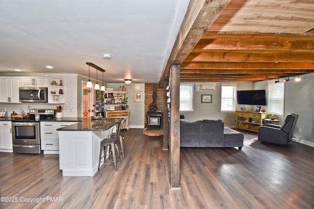 interior space with stainless steel appliances, white cabinets, open floor plan, dark wood-style floors, and open shelves