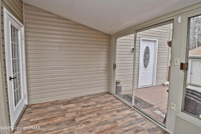 unfurnished sunroom with vaulted ceiling