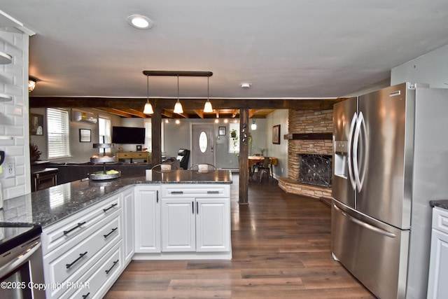 kitchen featuring dark wood-style floors, open floor plan, white cabinets, a stone fireplace, and stainless steel fridge with ice dispenser