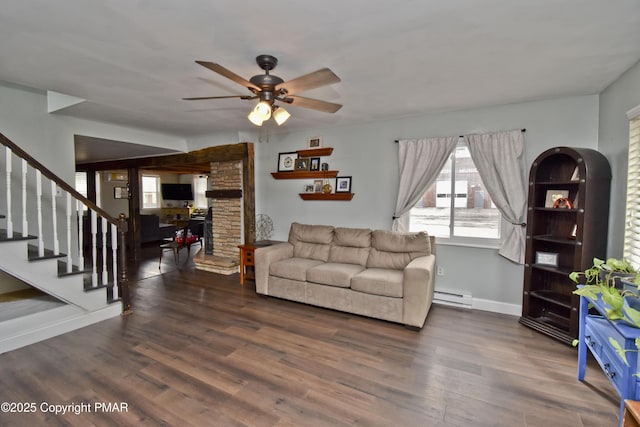 living room featuring baseboards, a ceiling fan, stairway, wood finished floors, and baseboard heating