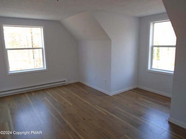 bonus room with baseboards, lofted ceiling, baseboard heating, and wood finished floors