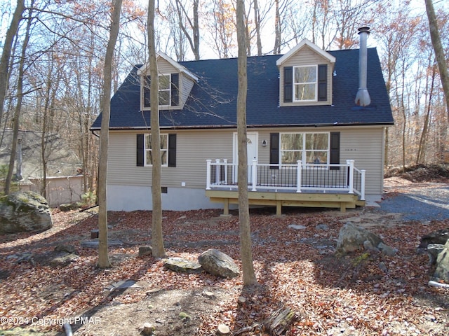 view of front of home featuring a wooden deck and a shingled roof