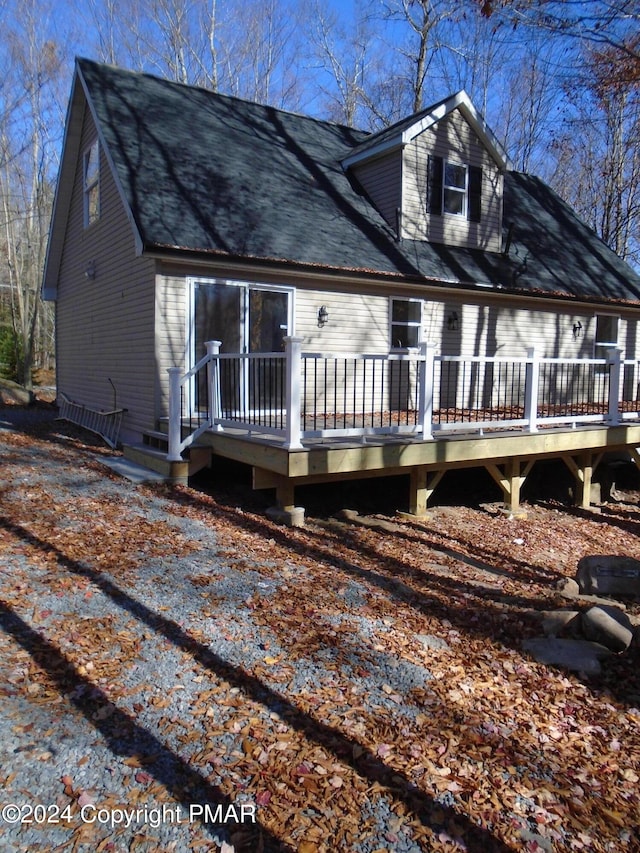 cape cod home with a deck