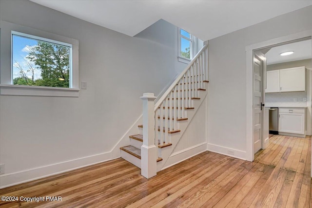 stairs with baseboards and hardwood / wood-style floors