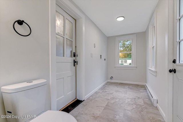 entryway with marble finish floor, a baseboard radiator, and baseboards