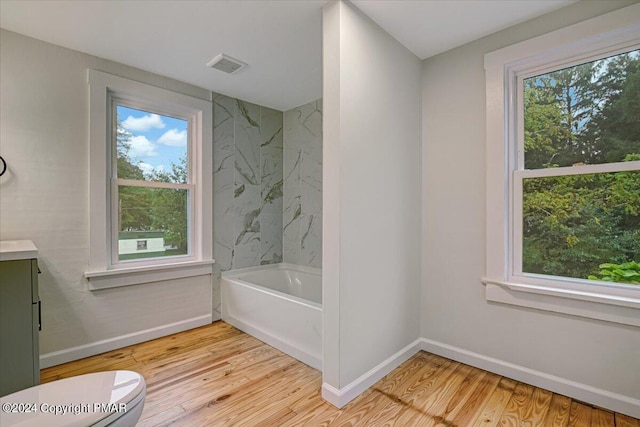 full bathroom featuring baseboards, visible vents, toilet, wood finished floors, and vanity