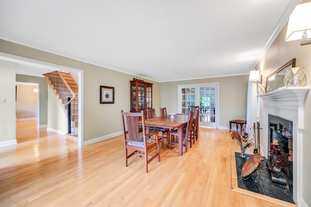 938 Meadow Cir, Bethlehem, PA 18017 - dining area with stairs, a fireplace, light wood-style floors, french doors, and crown molding