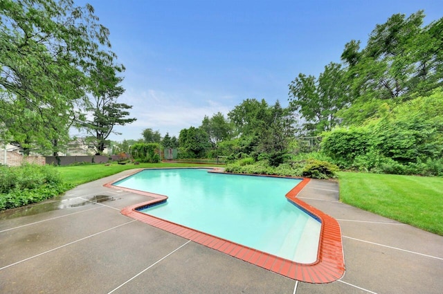 938 Meadow Cir, Bethlehem, PA 18017 - swimming pool with a lawn, a patio area, and view of wooded area