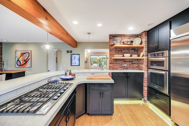 938 Meadow Cir, Bethlehem, PA 18017 - kitchen with appliances with stainless steel finishes, light wood-type flooring, light countertops, beam ceiling, and decorative light fixtures