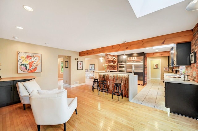 938 Meadow Cir, Bethlehem, PA 18017 - living room with bar with sink, light wood finished floors, recessed lighting, and beamed ceiling